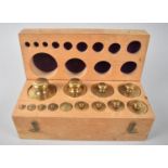 A Cased Set of Graduated Brass Metric Weights of Cylindrical Form, 22cms Wide