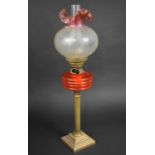 A Late 19th/Early 20th Century Brass Based Ribbed Column Oil Lamp with Orange Glass Reservoir and