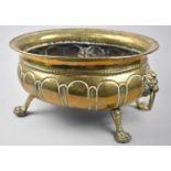 An Edwardian Brass Oval Planter with Lion Mask Ring Handles and Four Claw Feet, 38cms Wide