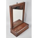 An Edwardian Wall Hanging Hall Mirror with Glove Box, 29cms Wide and 47cms High