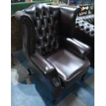 A Modern Leather Effect Button Upholstered Wing Armchair