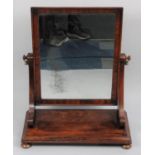 A Late Victorian Mahogany Swing Mirror on Rectangular Plinth Base with Four Bun Feet, 58cms Wide