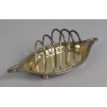 A Silver Toast Rack on Raised Boat Shaped Dish by Josiah Williams & Co (George Maudsley Jackson &