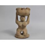 A Mid 20th Century African Carved Wooden Tribal Souvenir in the Form of Kneeling Maiden Holding Bowl