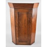 A Narrow Oak Hanging Corner Cabinet with Panelled Door to Shelved Interior, 41cms Wide and 69cms