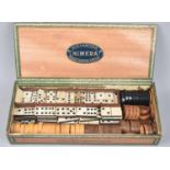 A Cigar Box Containing Turned Wooden Draughts Pieces and Bone Six and Nine Spot Dominoes