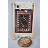 A Miniature Modern Carpet Loom with Rug On Display together with a Circular Teapot Stand, Loom