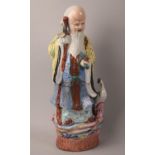 A Large Chinese Glazed Stoneware Figure of Standing Immortal holding Peach Beside Crane, 35cms High