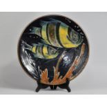 A Spanish Glazed Terracotta Charger Decorated with Fish, 35cm Diameter
