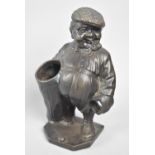 A Reproduction Patinated Bronze Novelty Desktop Pen Holder in the Form of Pot Bellied Gent with Golf