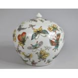 A 20th Century Chiense Jar and Cover of Flattened Globular Form Decorated with Butterflies, Four Red