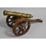 A Large Brass and Wooden Model of a Spanish Cannon, 61cms Long
