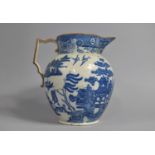 A Large 19th Century Pearlware Sparrow Beak Blue and White Willow Pattern Jug, 26cm high, Some