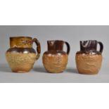 Three 19th/20th Century Glazed Stoneware Jugs all Decorated in Relief with Tavern, Windmill and