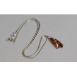 A Silver and Amber Pendant on Silver Chain