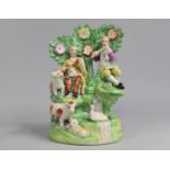 A 19th Century Staffordshire Study of Lovers in Briar with Sheep and Musical Instruments, 22cm high