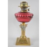 A Late 19th Century Brass and Cranberry Glass Oil Lamp, The Support in the Form of The Top Section