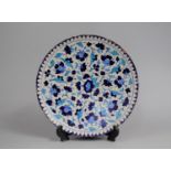 A Glazed Charger Decorated in Blue Enamels in the Iznik Style 30cm Diameter