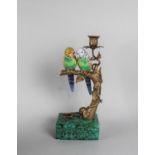 A Reproduction French Style Bronze and Ceramic Candlestick Decorated with Parrots Perched on a