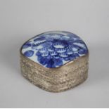 A Far Eastern White Metal Bowl with Blue and White Glazed Ceramic Lid Depicting Flowers, 8.5cms Wide