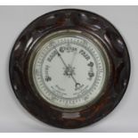 A Mid 20th century Carved Oak Mounted Circular Aneroid Barometer with Presentation Plaque Dated