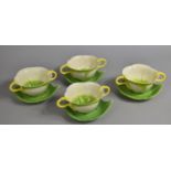 A Set of Four Mustardseed Moonshine Two Handled Soup Bowls and Saucers, the Cups Stylised as Lillies