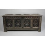 An Early Oak Four Panel Lift Top Coffer Chest with Carved Lozenge Decoration