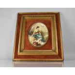 A Continental Cushion Framed Oval Enamel Plaque in the Vienna Style depicting Seated Maiden with