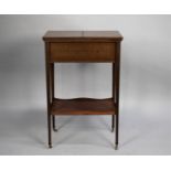 An Edwardian Mahogany Lift Top Two Division Sewing Box on Tapering Square Supports with Stretcher