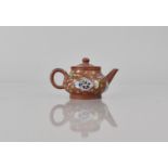 A Small Chinese Yixing Teapot decorated in the Famille Rose Palette with Fish amongst Reeds of