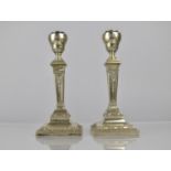 A Pair of White Metal Neo-Classical Candlesticks with Iron Loaded Bases, 20cms High
