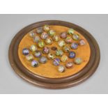 A Turned Wooden Solitaire Board Housing 32 19th Century German Latticino Marbles, Board 23cms