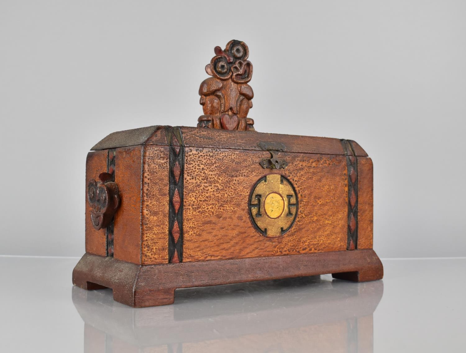 An Early 20th Century New Zealand Maori Carved Wooden Box, Top Decorated with a Carved Hei-Tiki