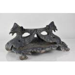 A Cast Iron Boot Scraper in the Form of Winged Griffin on Scrolled Rectangular Base, Possibly