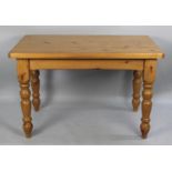 A Modern Rectangular Pine Kitchen Table, Turned Supports, 122cms by 76cms