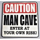 A Modern Cast Iron and Painted Square Sign, 'Caution, Man Cave'!, 24.5cms Square