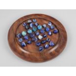 An Indonesian Wooden Solitaire Board Containing Various Sized Marbles, 22cs Diameter
