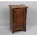 An Edwardian Mahogany Bedside Cabinet with Panelled Door to Shelved Interior, 68cms High and 46cms