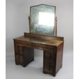 A Mid 20th Century Oak Kneehole Dressing Table with Two Long and Two Short Drawers Either Side