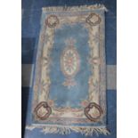 A Chinese Patterned Woollen Rug on Blue Ground, 154x89cm