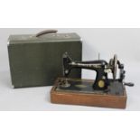 A Vintage Singer Manual Sewing Machine with carry case