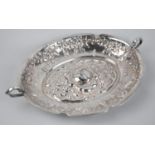 An Alpaca Metal Repousse Rose Decorated Oval Dish with Twin Handle, Stamped to Base, 33cm wide