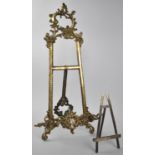 A Large Cast Brass Tabletop Picture Easel, 52cm high Together with a Smaller Silver Plated Example