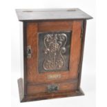 An Edwardian smoker's cabinet given as an athletics prize in 1912, panelled door to fitted