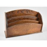 An Edwardian oak three division letter or stationery rack, 33cm wide.