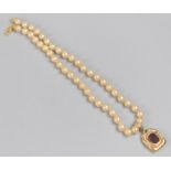 A Vintage Red Stone and Gilt Metal Pendant on Faux Pearl Necklace