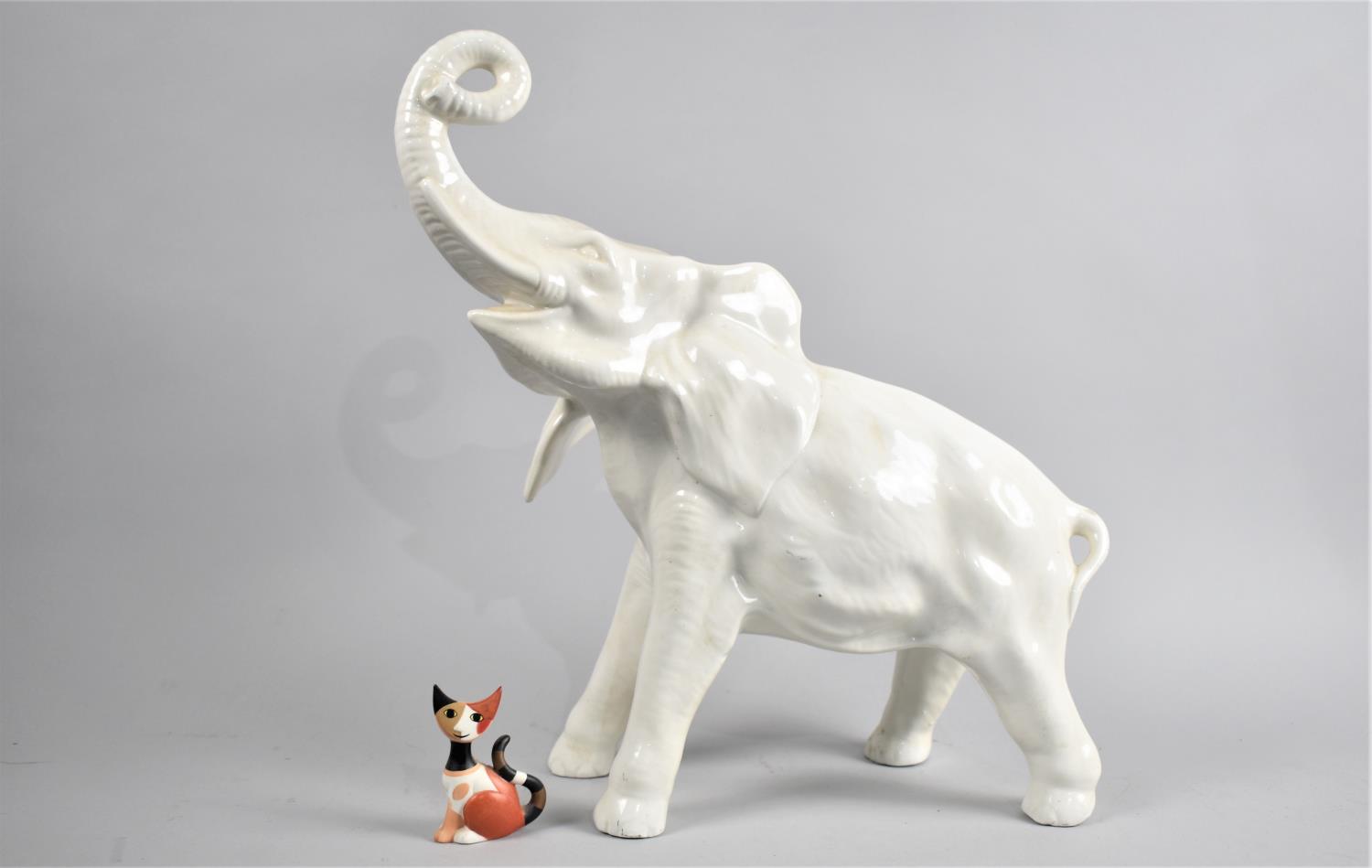 A Large White Glazed Ceramic Study of an Elephant Together with a Goebel Rosina Wachtmeister Cat