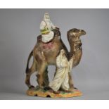 A Large Mid 20th Century Glazed Ceramic Figure Group, Arabic Woman Riding Camel with Gent Leading,