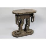 An African Carved Wooden Souvenir Stool, the Supports in the Form of Elephant with Human Legs,