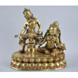 A Thai Gilt Bronze Figure Group Depicting Seated God and Goddess Playing Drum, on Oval Lotus Throne,
